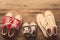 Three pairs of shoes lay on the wooden floor of the family, parents and children to do together