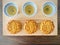 Three Pandan Mooncake and three cups of tea on wooden background. Top view.