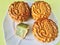 Three Pandan Seed paste MoonCake with a portion cutout, light green background.