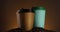 Three paper coffee cups spinning. Disposable cups for hot drinks. Coffee beans. Espresso, latte, cappuccino for take away
