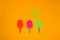 three paper ice creams on a stick, orange, pink and green that exploded on a yellow background, summer modern design