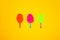 three paper ice creams on a stick, orange, pink and green on a yellow background, summer modern design