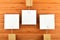 Three paper notesin different directions on wooden background