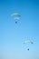 Three paraglider fly in summer sunny day. Carpathians, Ukraine.