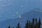 Three paragliders flying in the mountains