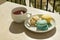 Three Parisian-style macarons and cup with cardamon tea