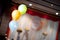 Three pastel balloons decorated in the wedding hall