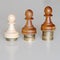 Three pawns chess pieces on columns of coins, symbolizing substantial income inequality