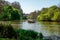 Three pelicans sitting on a rock in the middle of St James`s Park lake, London