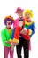 Three people dressed up as colorful funny clowns