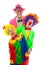 Three people dressed up as colorful funny clowns