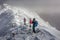Three people make their way through the clouds at the Rila mountain in Bulgaria, Maliovica