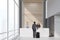 Three people near a reception desk