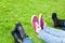 Three people shoes on grass