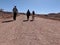 Three people walking in the outback, Coober Pedy, red centre of Australia