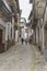 Three people walking and sightseeing through the narrow streets of Candelario, Salamanca, Castilla Leon, Spain.