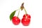 Three perfect sweet cherries with cherry leaf isolated on a white background