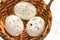 Three perforated Easter eggs in wicker basket