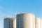 Three petrol tanks on blue sky background. Storage in Riga.