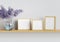 Three photo mockup frames and bouquet of lilac blossoms on the shelf. Clipping path included. 3D render.
