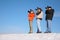 Three photographers on snow hill