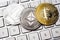 Three physical metal coins - Litcoin, Ethereum and Bitcoin on keyboard. Cryptocurrency concepts