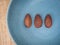 Three piece smoked almonds display on blue indigo plate background