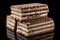 Three pieces of brown and white puff waffle cakes with boiled condensed milk isolated on black background with reflection on