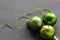 Three pieces Christmas balls green on grey background