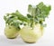 Three pieces of kohlrabi vegetable isolated on yellow simple background with copy space