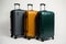 three pieces of luggage of similar size and different color