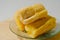 Three pieces of tapai or fermented cassava on a small plate