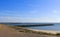 Three piers in the sea along the seawall in zeeland, holland