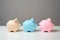 Three piggy banks lined up in a chain. Savings management.