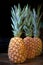 Three pineapples in a row on wooden table