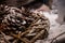 Three pinecones nestled in wooden handmade wreath covered in fake snow