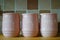 Three pink jugs on a wooden kitchen work surface, with the words