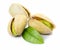 Three pistachio nuts with leaf