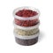 Three plastic containers with superfood, dried goji berries , cacao nibs and hemp seed on white background