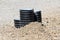 Three plastic pipes sticking out of ground surrounded with gravel at local construction site