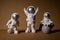 Three Plastic toys figure astronaut on beige background Copy space. Concept of out of earth travel, private spaceman