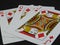 Three playing cards: King, Queen and Jack of Diamonds.