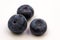 Three Plump Blueberries on a white background