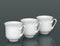 Three porcelain cups in row with DOF