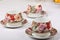 Three porcelain teacups with floral pattern on a white tablecloth