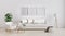 Three poster blank frames in Stylish interior of bright living room with white sofa and armchair, floor lamp, plant 