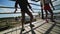 Three pretty women energetically dance on isolated stage at summer resort