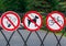 three prohibition signs on metal gates