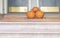 three pumpkins at the end of a staircase of a residential house