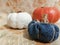 Three pumpkins. In the foreground of jeans, on the back decorative from the garden and crocheted